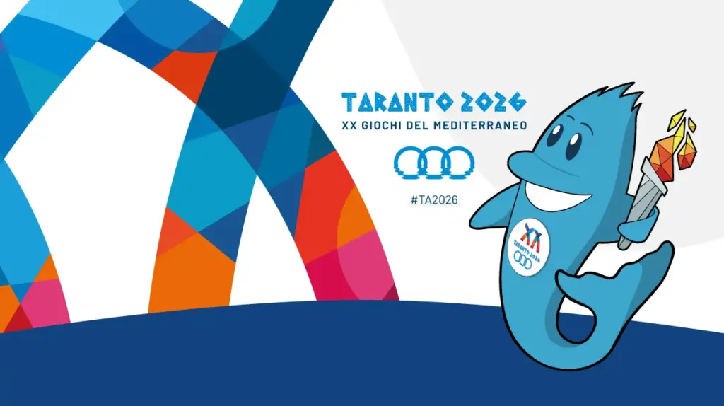 Logo ufficiale e mascotte a forma di delfino con torcia dei XX Giochi del Mediterraneo Taranto 2026.